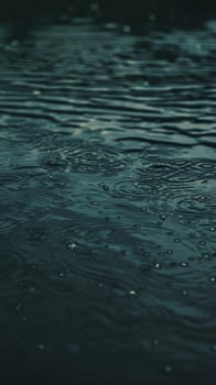 Raindrops create ripples on the surface of still water photo