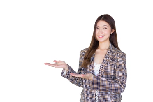 Asian professional woman with black long hair wearing aplaid suit and pretty smiling looking at camera is present product while isolated white background. photo