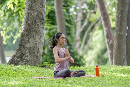Young Woman Practicing Yoga Outdoors in a Serene Park Setting, Embracing Nature and Tranquility for Mindfulness and Relaxation photo