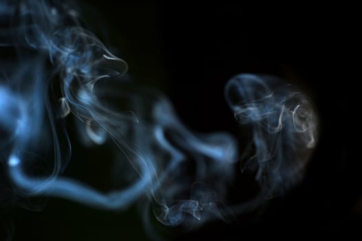 Ethereal Swirls of Smoke Against a Dark Background Capturing the Mystical and Abstract Beauty of Vapor photo