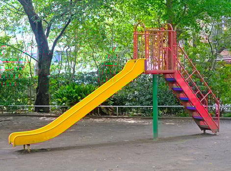 Yellow joyful slide for child and kids in Japanese residential playground photo