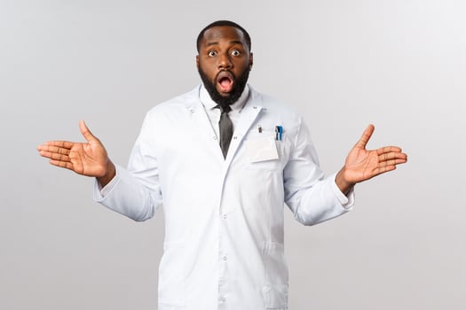 Covid19, healthcare and clinic concept. Portrait of surprised african-american doctor, spread hands sideways puzzled, gasping and staring startled camera, cant understand how it happened photo