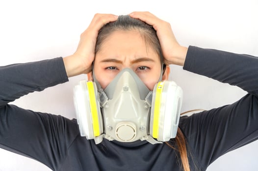 Portrait of young Asian woman wearing gas mask for protect smog bad air pollution or toxic. photo