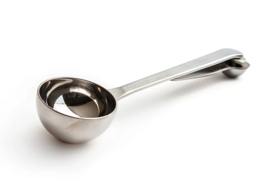 Stainless steel ice cream scoop on a white background. photo