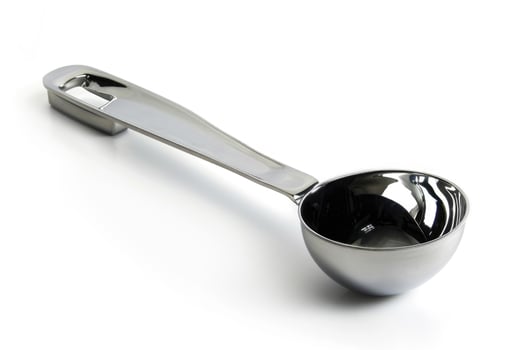 Stainless steel ice cream scoop on a white background. photo
