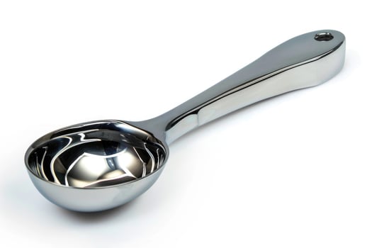 Stainless steel ice cream scoop on a white background. photo