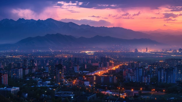 An expansive view of Almaty's cityscape at dusk with vibrant lights and mountains visible. photo