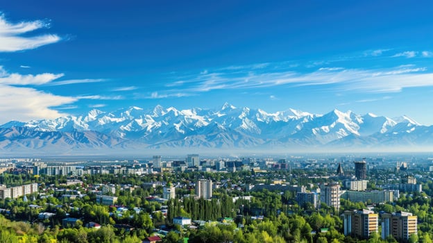 A sweeping view of Almaty with snow-capped mountains in the distance on a bright sunny day. photo