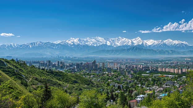 A sweeping view of Almaty with snow-capped mountains in the distance on a bright sunny day. photo