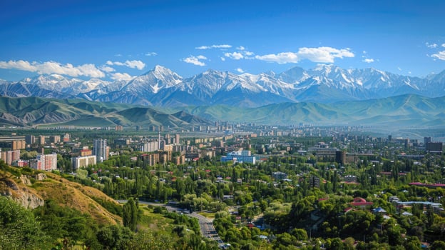 A sweeping view of Almaty with snow-capped mountains in the distance on a bright sunny day. photo