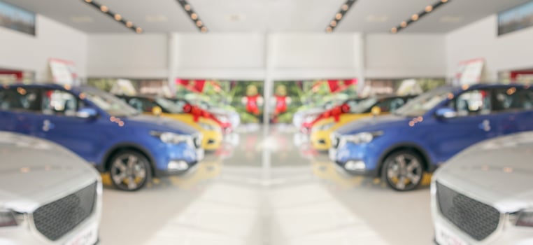 new cars in showroom interior blurred abstract background photo