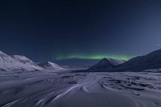 Northern Lights Dancing Over Snowy Mountains. Nature Background photo