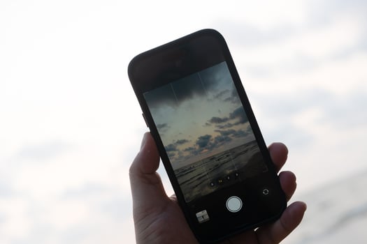 The concept of the photos on the phone on the beach.