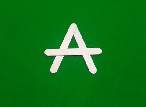 Letter A with Wooden Ice Cream Stick isolated on green chroma background photo