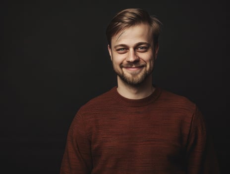 Smiling Male Executive Posing Against Dark Background in Casual Attire photo