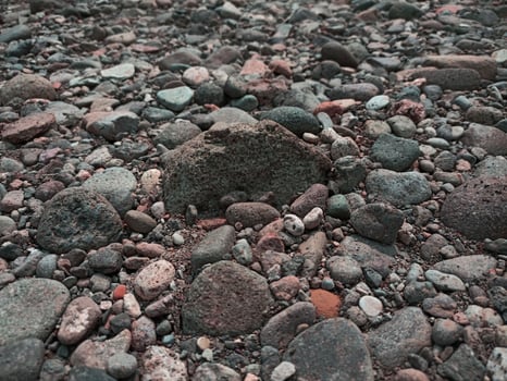 A rock is sitting on top of a pile of rocks photo