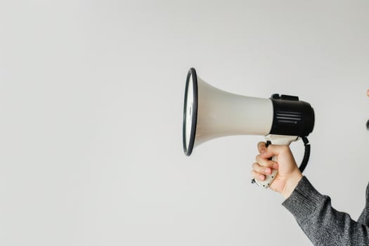 Hand holding a megaphone with a blank space for text photo