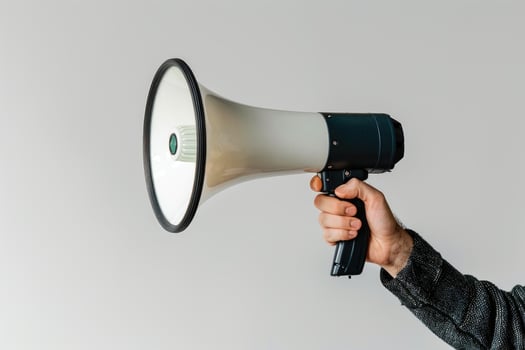 Hand holding a megaphone on a white background photo