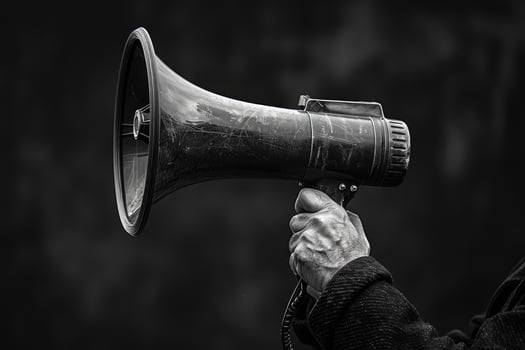 Protestor holding a megaphone to amplify message photo