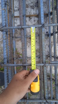 Mature construction worker measuring with tape photo
