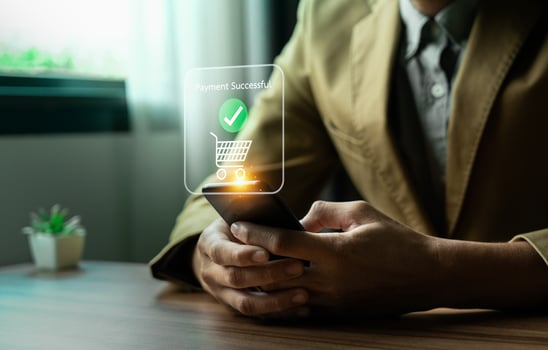 Person Making Online Payment with Credit Card on Laptop, Holographic Interface Showing Payment Successful and Shopping Icons, Representing E-commerce and Digital Transactions photo