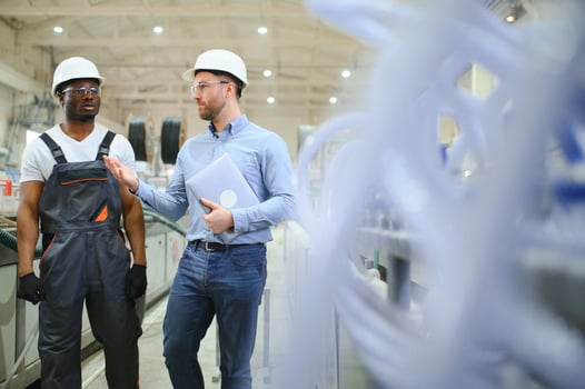 Two Heavy Industry Engineers Stand in Factory photo