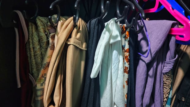 a closet with clothes hanging on hangers photo