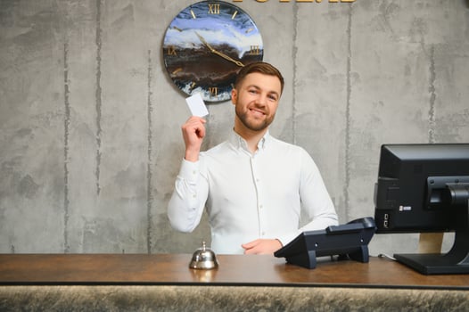 Portrait of receptionist at desk in lobby, hotel photo