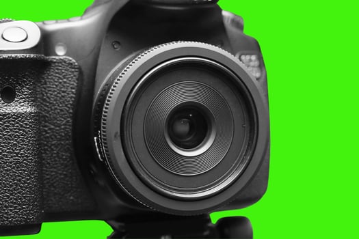 DSLR camera wih green background photo