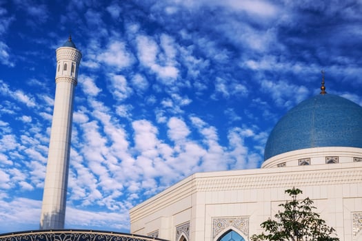 white minaret and blue dome of the Minor mosque on the background of sky with clouds in Uzbekistan in Tashkent photo