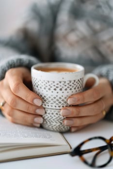 Woman's Hands Holding a Mug of Coffee photo