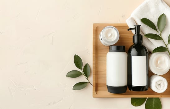 White Bottles and Cream Jar on Wooden Tray photo