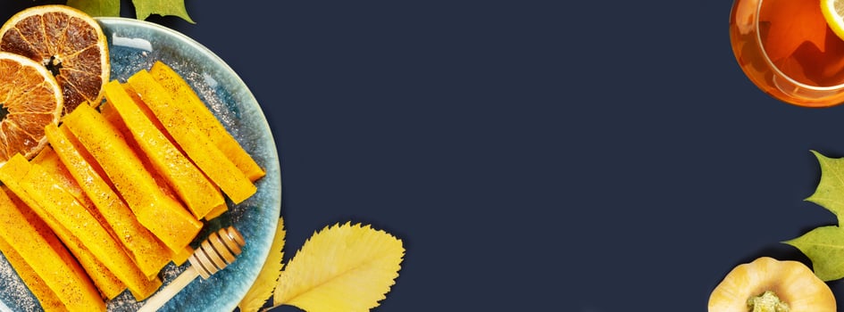 Food banner with baked pumpkin slices, cinnamon, honey and tea photo