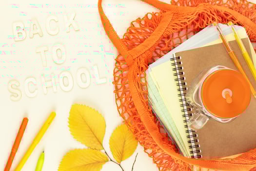 School supplies in a bright yellow textile bag photo