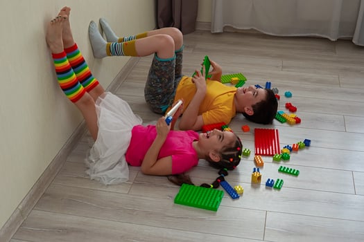 A happy boy and a little girl, lie on the floor photo