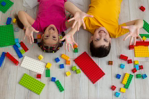 Portrait of happy boy and a little girl, lie on the floor photo