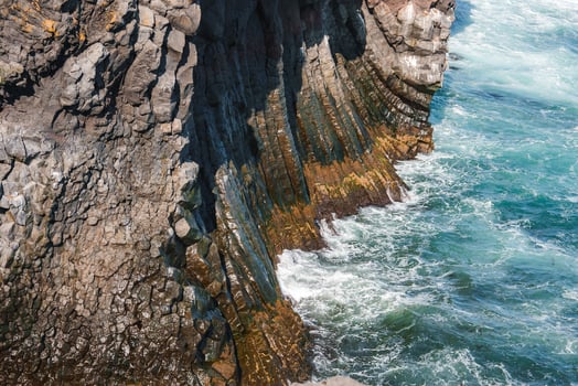 Dramatic Basalt Cliffs and Clear Blue Waters at Arnarstapi, Iceland photo