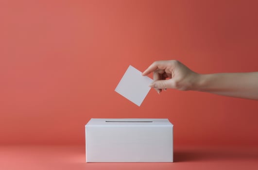 Hand Placing Ballot in Box photo