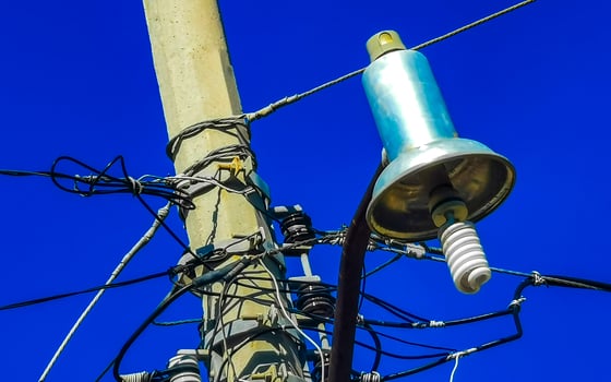 Power pole cable box with blue sky in Mexico. photo