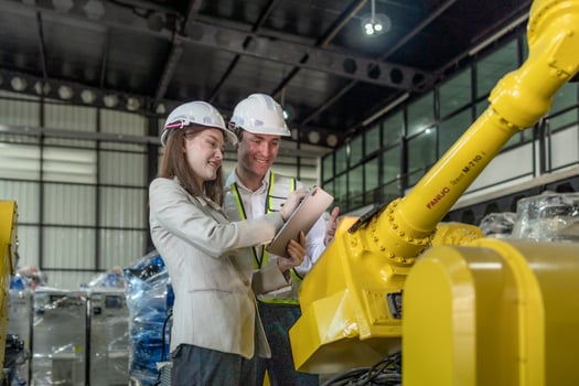 team engineers inspecting on machine with smart tablet. Worker works at heavy machine robot arm. The welding machine with a remote system in an industrial factory. Artificial intelligence concept. photo