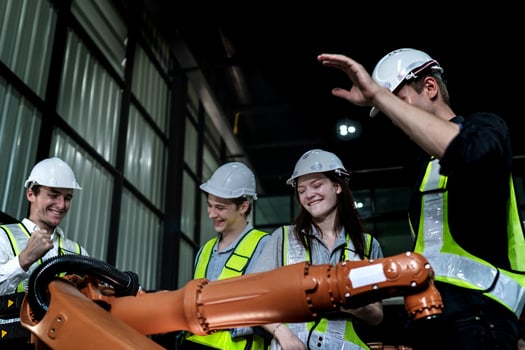 team engineers inspecting on machine with smart tablet. Worker works at heavy machine robot arm. The welding machine with a remote system in an industrial factory. Artificial intelligence concept. photo