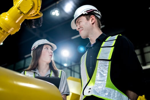 team engineers inspecting on machine with smart tablet. Worker works at heavy machine robot arm. The welding machine with a remote system in an industrial factory. Artificial intelligence concept. photo