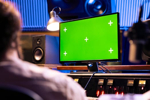 Singer and expert mixing and processing music for a new album in control room at professional recording studio, working on songs. Diverse team of artists producing a new tune. photo