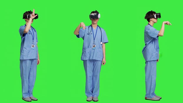 Health specialist using vr headset to examine patient diagnosis, stands against greenscreen backdrop. Nurse works with artificial intelligence virtual reality glasses, three dimensional. Camera A. photo