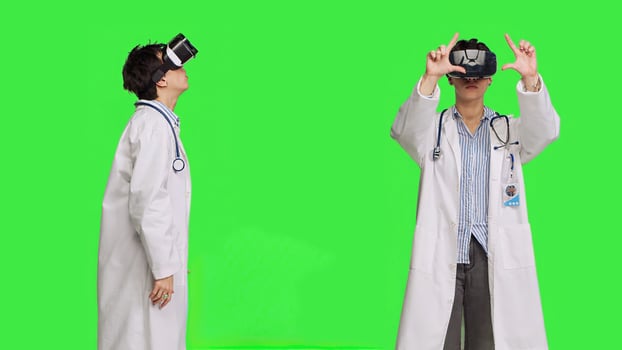 Physician consulting patients with virtual reality futuristic glasses, wears white coat against greenscreen backdrop. General practitioner uses artificial intelligence interactive headset. Camera B. photo