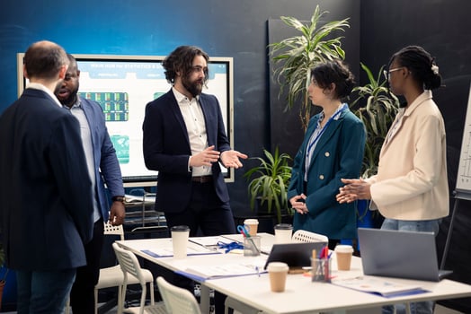 Group of corporate employees are meeting in a boardroom office, debating possible business deals or global collaborations. Coworkers starting a briefing session to share visions and ideas. photo