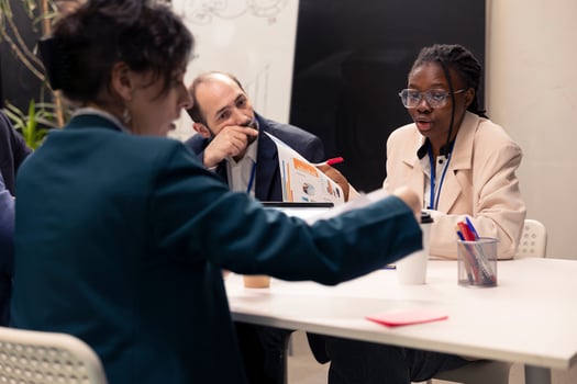 Team of colleagues working on resource allocation initiatives during a conference, making important budgeting decisions to corelate with business goals and objectives. Employees review strategies. photo