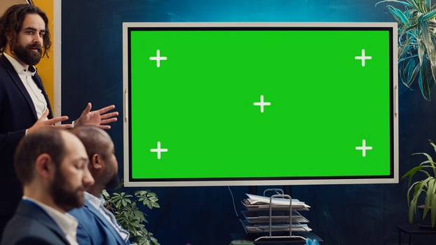 Sales management team working with isolated copyspace display in a briefing meeting, sharing ideas and practices to improve workflow. Organization affiliates gathered in a conference. Camera A. photo