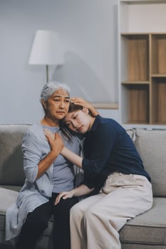 Sad teen granddaughter hugging depressed mature grandmother, giving support, help, comforting, consoling granny. Teenage daughter girl and middle aged mother going through family problems photo