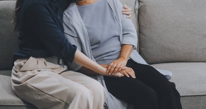 Sad teen granddaughter hugging depressed mature grandmother, giving support, help, comforting, consoling granny. Teenage daughter girl and middle aged mother going through family problems photo